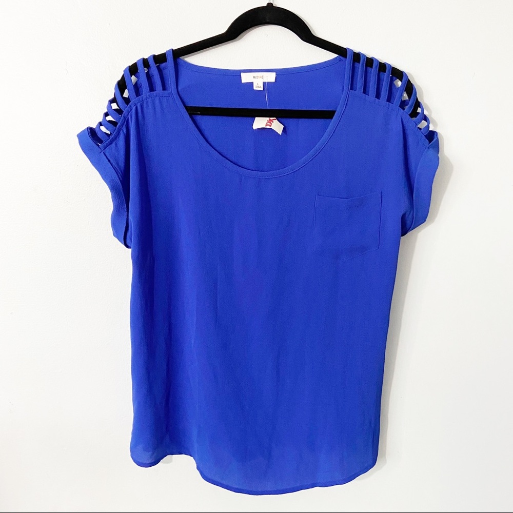 Blue top with shoulder detail.